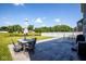 Stamped concrete patio with outdoor dining, umbrella and peaceful water view at 7128 Verwood Ct, Plainfield, IN 46168