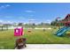 Large backyard with pond, playground, playhouse, and a fire pit, perfect for outdoor enjoyment at 757 Carson Ln, Greenfield, IN 46140
