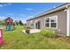 Spacious backyard with a patio, playground, a pond view, and lovely landscaping at 757 Carson Ln, Greenfield, IN 46140