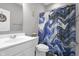 Bathroom with a modern vanity, toilet, and a blue and gold patterned shower curtain at 757 Carson Ln, Greenfield, IN 46140