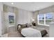 Bright bedroom with paneled accent wall, carpeted floors, and large windows overlooking the neighborhood at 757 Carson Ln, Greenfield, IN 46140