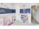 Bedroom with playful rainbow-themed decor and organized storage for books, toys, and stuffed animals at 757 Carson Ln, Greenfield, IN 46140