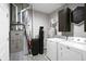 Laundry room with front loading washer and dryer, water heater, and a charming laundry rules sign at 757 Carson Ln, Greenfield, IN 46140