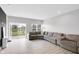Comfortable living room with gray sectional sofa and sliding glass doors to a backyard lake view at 757 Carson Ln, Greenfield, IN 46140