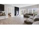 Open living room with a large gray sectional, black accent wall, and view to the backyard at 757 Carson Ln, Greenfield, IN 46140
