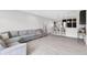 Spacious living room with open layout, gray sectional, and breakfast bar with seating at 757 Carson Ln, Greenfield, IN 46140