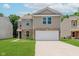 Two-story home with a two car garage, brick accents, well-kept lawn, and neutral colored siding at 8248 Ossian Ct, Camby, IN 46113