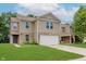 Two-story home with a two car garage, brick accents, well-kept lawn, and neutral colored siding at 8248 Ossian Ct, Camby, IN 46113