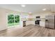 Modern kitchen with white cabinets, stainless steel appliances, granite countertops, and sliding door to the yard at 8248 Ossian Ct, Camby, IN 46113