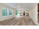 Bright open living area with white kitchen, stainless appliances, and a sliding glass door leading to the backyard at 8248 Ossian Ct, Camby, IN 46113