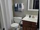 Cozy bathroom featuring a toilet, towels, sink with vanity, and a shower with curtain at 8460 Ferguson Cir, Avon, IN 46123