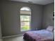 Bedroom with soft grey walls, plush carpeting, and a queen size bed at 8460 Ferguson Cir, Avon, IN 46123