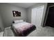 Bedroom with soft grey walls, plush carpeting, and a queen size bed at 8460 Ferguson Cir, Avon, IN 46123