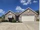 Charming single-story brick home with well-manicured landscaping and attached two-car garage at 8460 Ferguson Cir, Avon, IN 46123