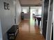Hallway with wood floors, bench with shoe rack, and decoratively painted grey walls at 8460 Ferguson Cir, Avon, IN 46123