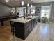A large kitchen island with granite countertops and stainless steel sink and faucet at 8460 Ferguson Cir, Avon, IN 46123