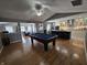 A spacious living area with hardwood floors open to eat-in kitchen and featuring a pool table at 8460 Ferguson Cir, Avon, IN 46123