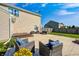 This backyard features a concrete patio with lounge seating, a deck, and a well-maintained lawn under a sunny blue sky at 8557 Vyners Ln, Avon, IN 46123