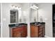 Bathroom with dual sinks, wood cabinets, and updated fixtures and a stand up shower at 8557 Vyners Ln, Avon, IN 46123