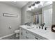 Bright bathroom featuring double sinks, gray tile floor, and white cabinets at 8557 Vyners Ln, Avon, IN 46123