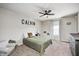 Bright bedroom featuring a ceiling fan, carpeted floors, and natural light from the window at 8557 Vyners Ln, Avon, IN 46123