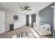 Bright Bedroom with a crib, large window, carpeted floor, and gray accent wall at 8557 Vyners Ln, Avon, IN 46123