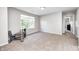 Inviting bonus room showcases light gray walls, neutral carpet, and a window, creating a cozy atmosphere at 8557 Vyners Ln, Avon, IN 46123