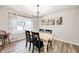 The dining room has a light wood table with black chairs and large window at 8557 Vyners Ln, Avon, IN 46123