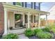Inviting front porch with rocking chairs, a welcome sign, and lovely landscaping that adds charm to the home's entrance at 8557 Vyners Ln, Avon, IN 46123