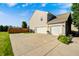 Attached two-car garage with a concrete driveway and well-maintained landscaping, offering convenience and curb appeal at 8557 Vyners Ln, Avon, IN 46123