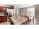 Bright kitchen with an island, stainless refrigerator, and an adjacent breakfast nook at 8557 Vyners Ln, Avon, IN 46123