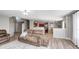 Open living area with cozy seating, staircase, and views of the kitchen and dining room at 8557 Vyners Ln, Avon, IN 46123