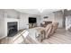 Inviting living room features fireplace, hardwood flooring, and ample seating at 8557 Vyners Ln, Avon, IN 46123