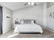 Bright main bedroom boasts a ceiling fan, neutral carpet, and a king bed, creating a comfortable retreat at 8557 Vyners Ln, Avon, IN 46123