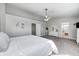 Spacious main bedroom boasts an ensuite bathroom, neutral carpet, gray walls, and natural light at 8557 Vyners Ln, Avon, IN 46123
