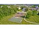Aerial view of a neighborhood playground, including a basketball court and green space at 8557 Vyners Ln, Avon, IN 46123