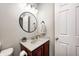 Cozy powder room featuring vanity with a round mirror at 8557 Vyners Ln, Avon, IN 46123