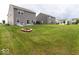 Spacious backyard featuring a patio, fire pit, and well-maintained lawn ideal for outdoor living at 9309 Kellner St, Pendleton, IN 46064
