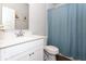 Clean bathroom with a white vanity, granite countertop, and a shower with a blue curtain at 9309 Kellner St, Pendleton, IN 46064