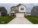 Charming two-story home with gray siding, white trim, and a spacious driveway leading to a two-car garage at 9309 Kellner St, Pendleton, IN 46064
