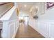 Bright foyer with hardwood floors and decorative wall paneling, leading to the dining and living areas at 9309 Kellner St, Pendleton, IN 46064