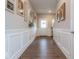 Bright foyer with hardwood floors and decorative wall paneling, leading to the stairway and other living areas at 9309 Kellner St, Pendleton, IN 46064