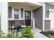 Inviting front porch with seating area, decorative door, and brick accents creating a warm welcome at 9309 Kellner St, Pendleton, IN 46064