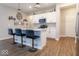 Stylish kitchen with stainless appliances, white cabinets, a center island with bar stools, and hardwood floors at 9309 Kellner St, Pendleton, IN 46064