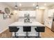 Bright kitchen features a large island with seating, stainless appliances, and white cabinetry at 9309 Kellner St, Pendleton, IN 46064