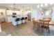 Open-concept kitchen with stainless appliances, white cabinets, island with seating, and adjacent dining area at 9309 Kellner St, Pendleton, IN 46064
