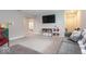 Spacious living room featuring gray sofa and entertainment area with walk through to the play room at 9309 Kellner St, Pendleton, IN 46064