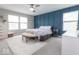 Bright primary bedroom with blue accent wall, ample natural light, and soft carpet at 9309 Kellner St, Pendleton, IN 46064