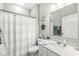 Bathroom equipped with a toilet, vanity, sink, mirror, and shower with curtain at 10814 Matherly Way, Noblesville, IN 46060
