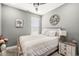 Bedroom featuring a ceiling fan, bed, side table, wall decor, and window at 10814 Matherly Way, Noblesville, IN 46060